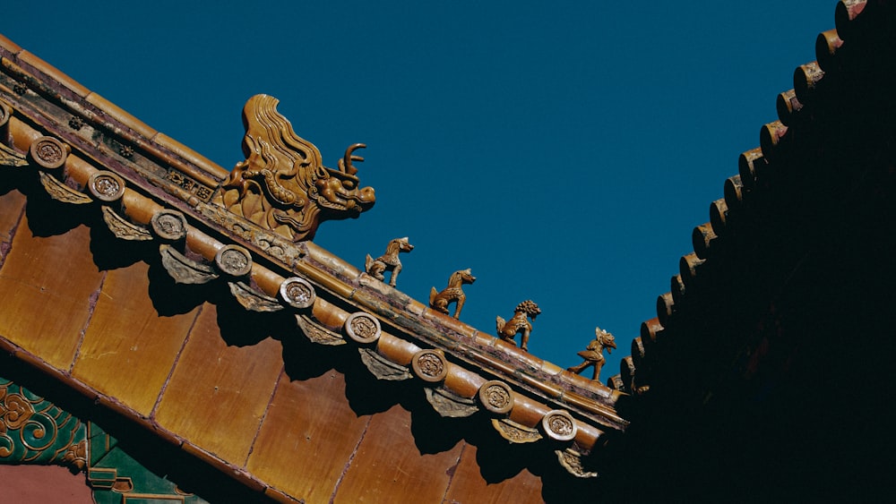 a gold and bronze statue on a wooden surface