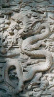 a stone sculpture of a person riding a horse