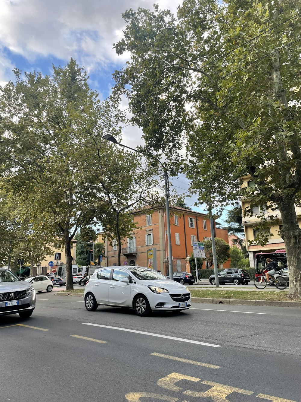 a white car parked on the side of a road