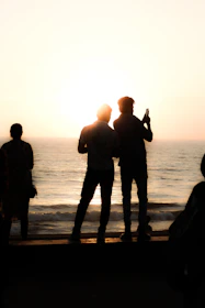 a group of people standing on a beach