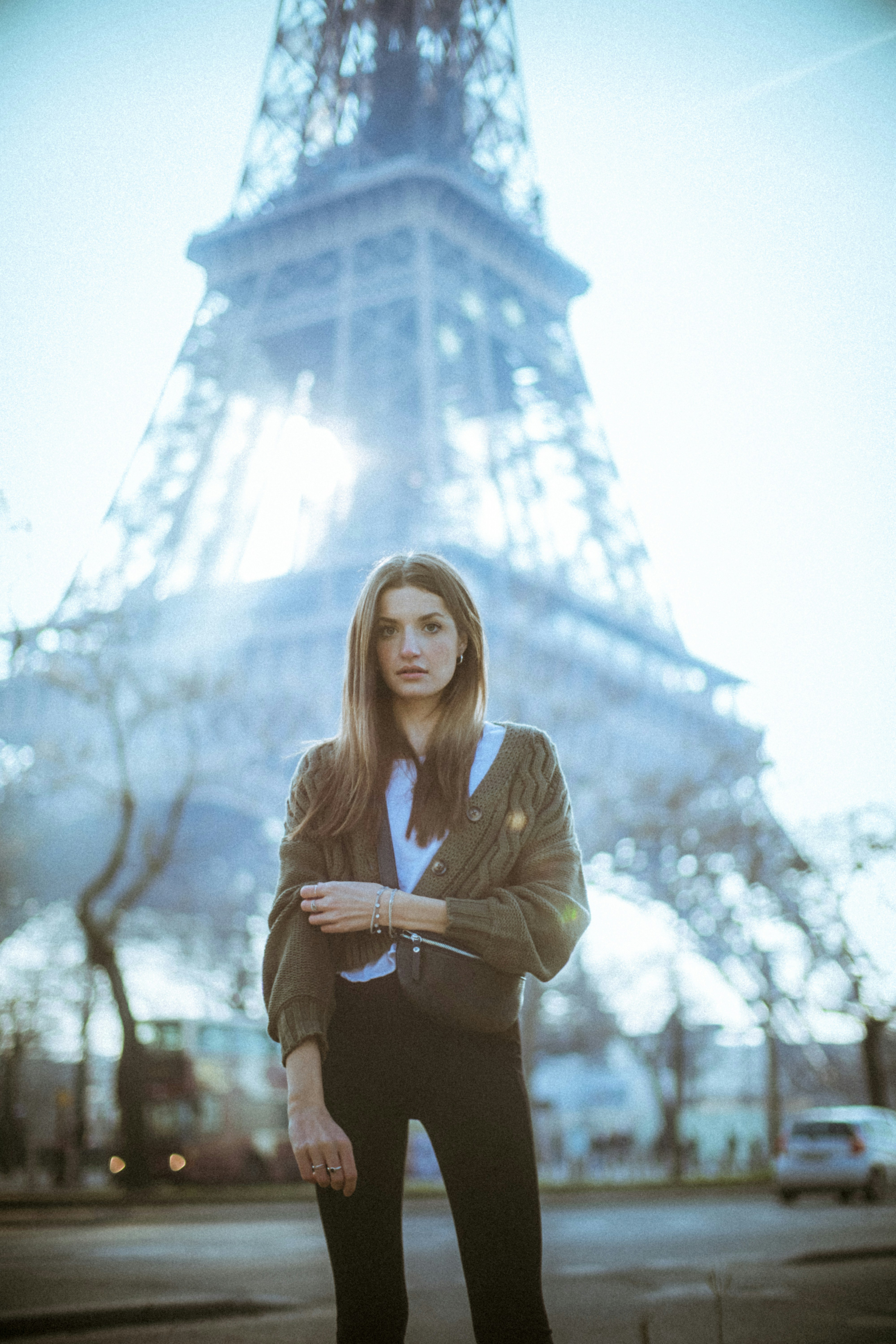 a woman posing in front of a tall tower