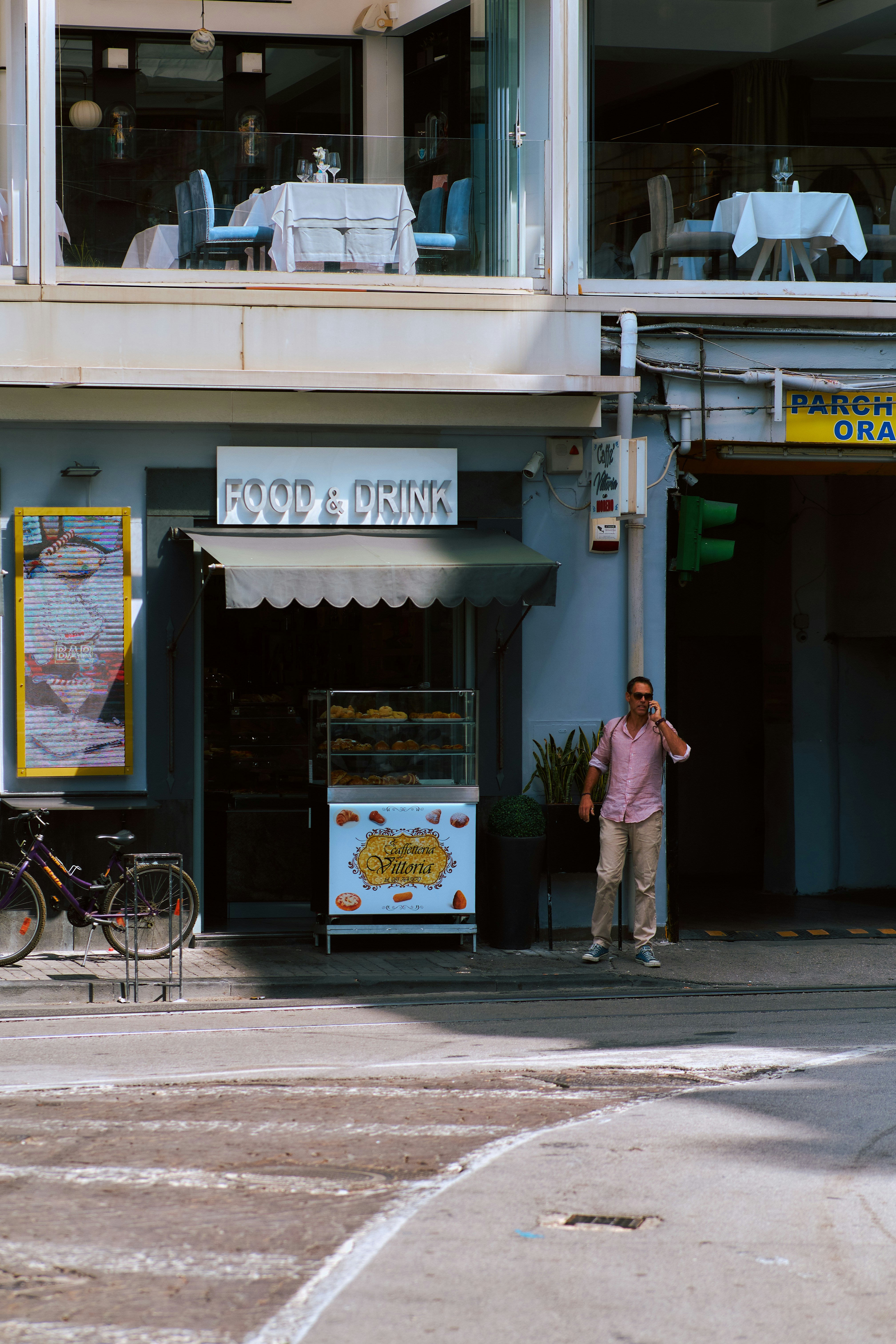 A person standing in front of a storefront photo – Free Napoli Image on ...