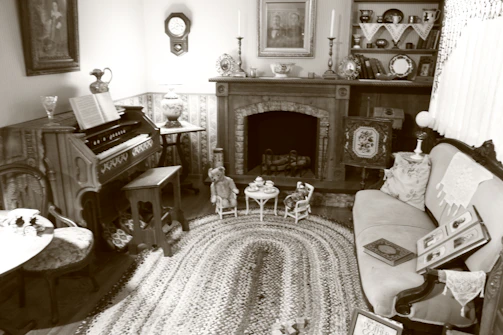 A cozy living room filled with vintage furniture and carefully arranged antiques ready for an estate sale.