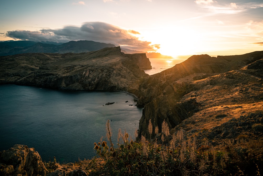 a body of water with hills around it