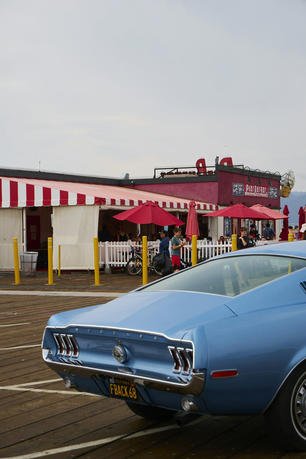 a blue car parked in front of a red and white building