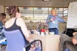 a woman explaining something to a group of people