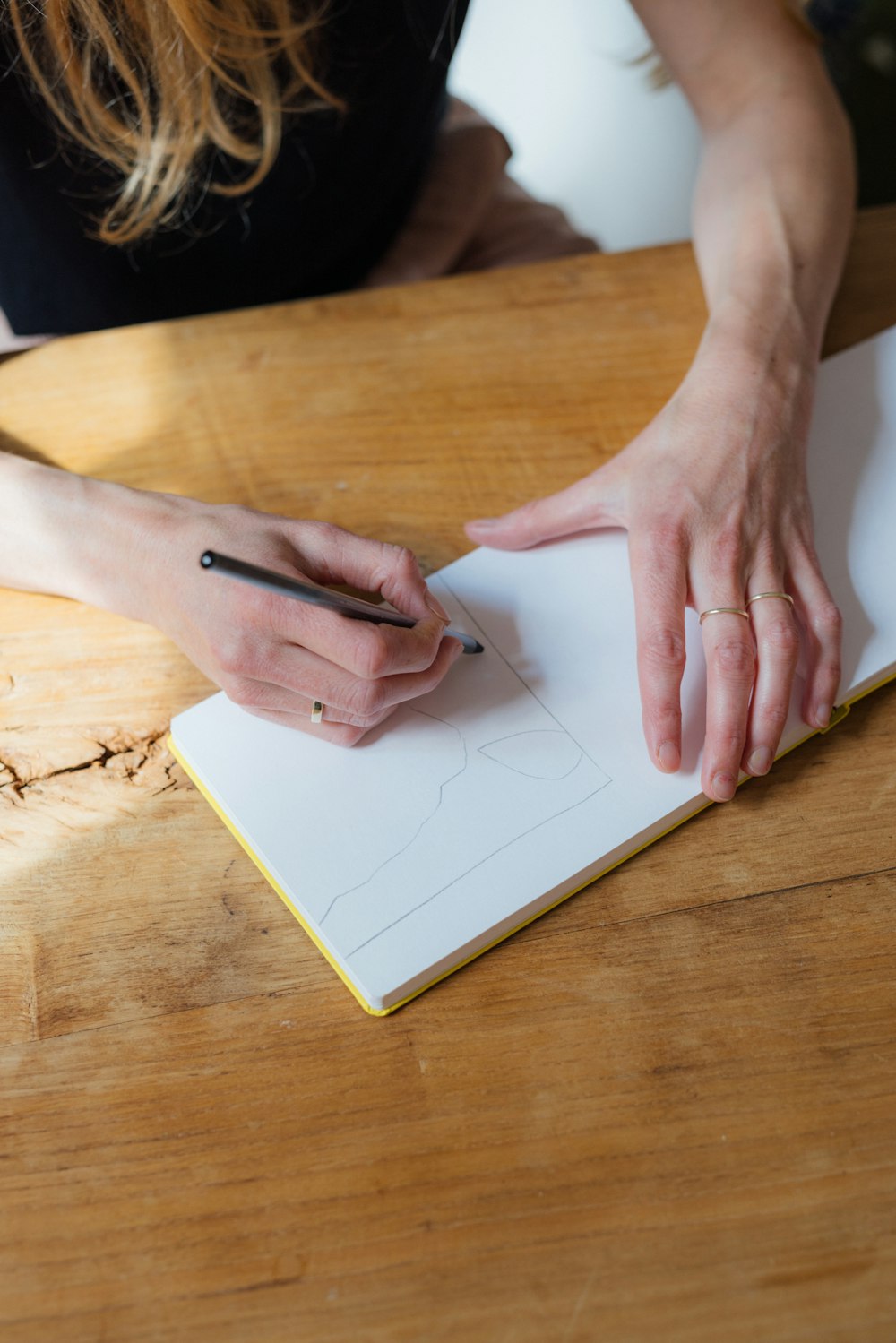 a person writing on a piece of paper