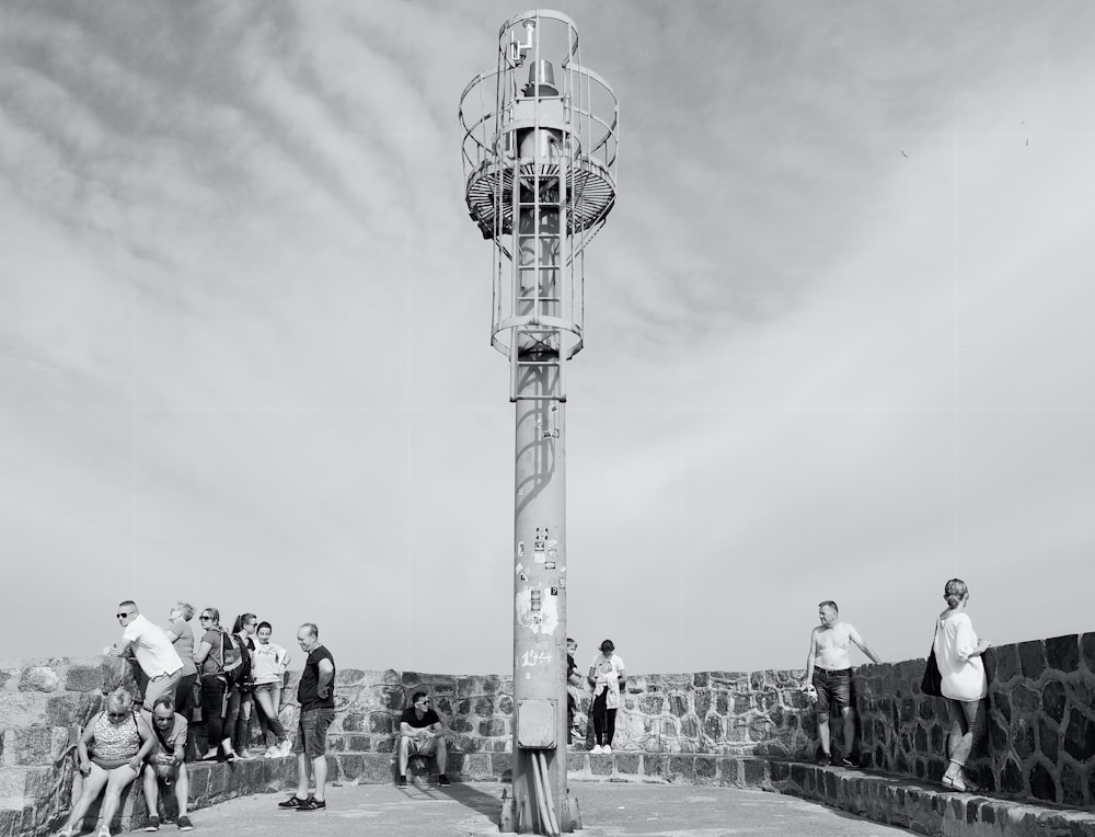 a group of people standing on a bridge