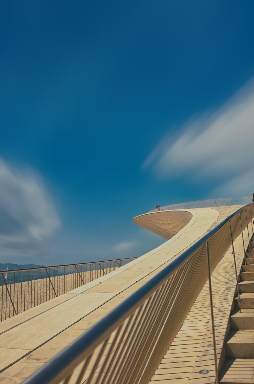 a wooden bridge with a railing