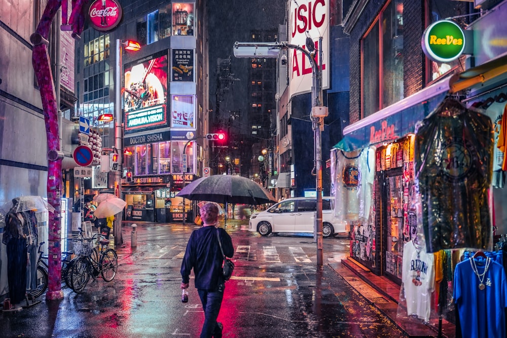 a person walking down a sidewalk with an umbrella