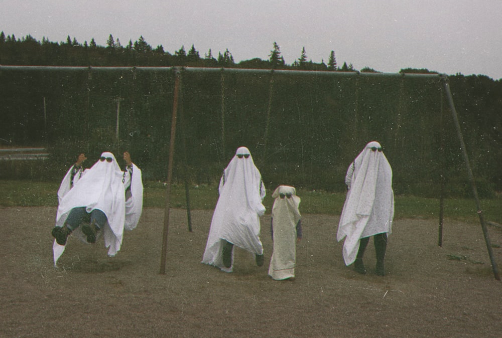 a group of people wearing white robes