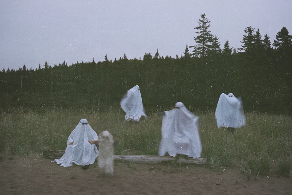 a group of people wearing white robes