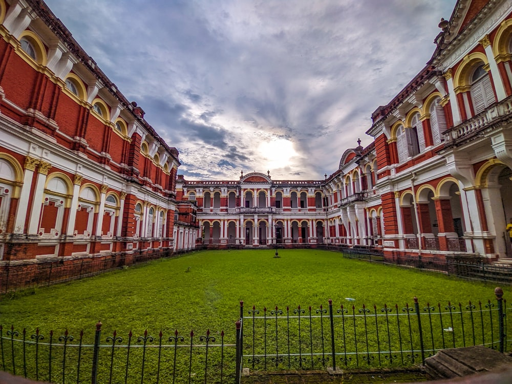 a large building with a green lawn