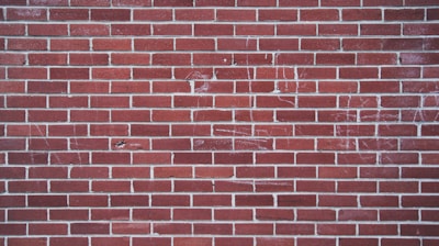 Workers inspecting uniform bricks lined up for quality control.