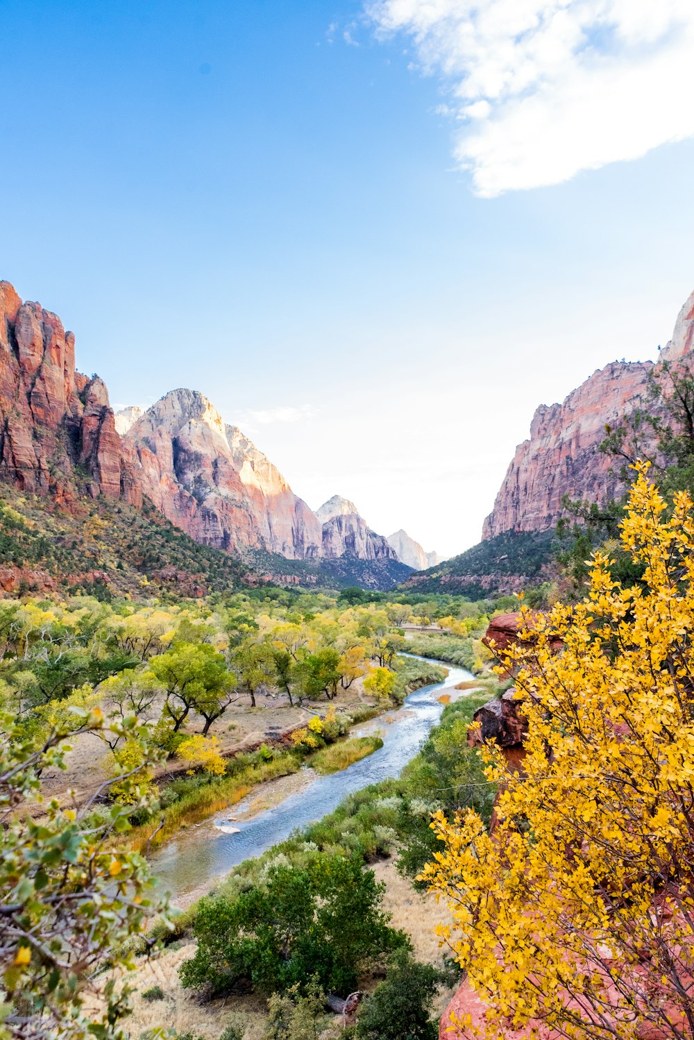 a river running through a valley between mountains