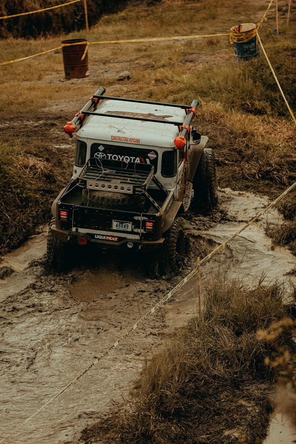 a truck driving down a dirt road