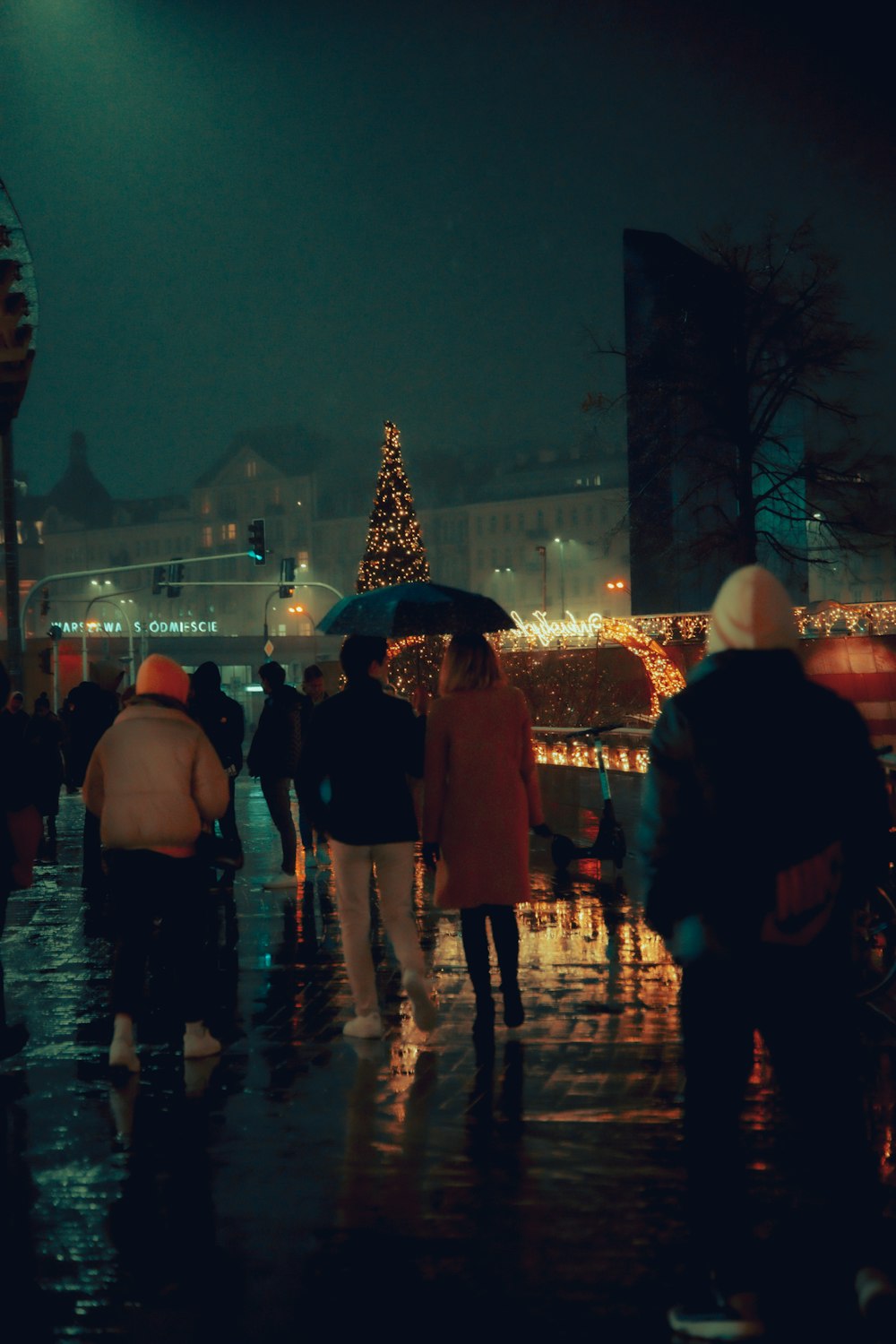 people walking in the rain with umbrellas