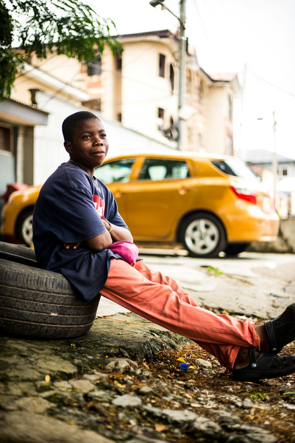 a boy sitting on a tire