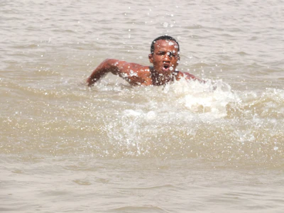 A close-up of a swimmer's hand slicing through the water.