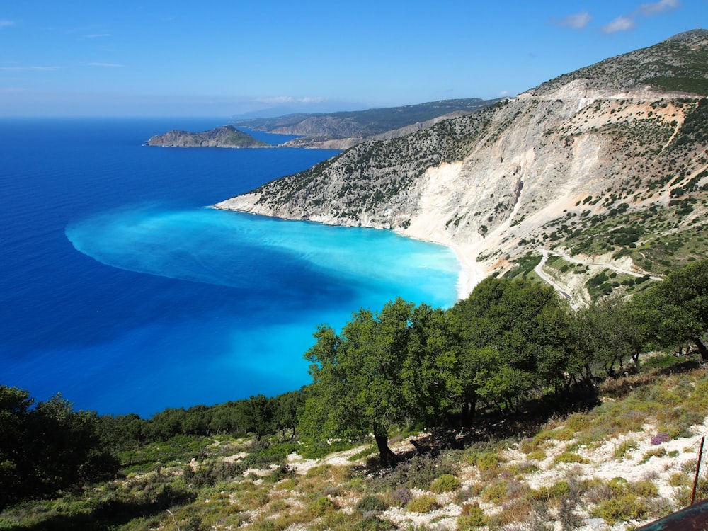 a body of water with trees and mountains around it