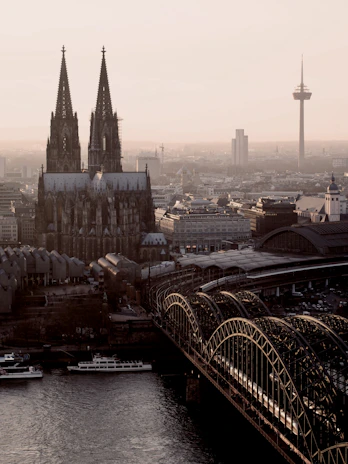 a bridge over a river with a city in the background