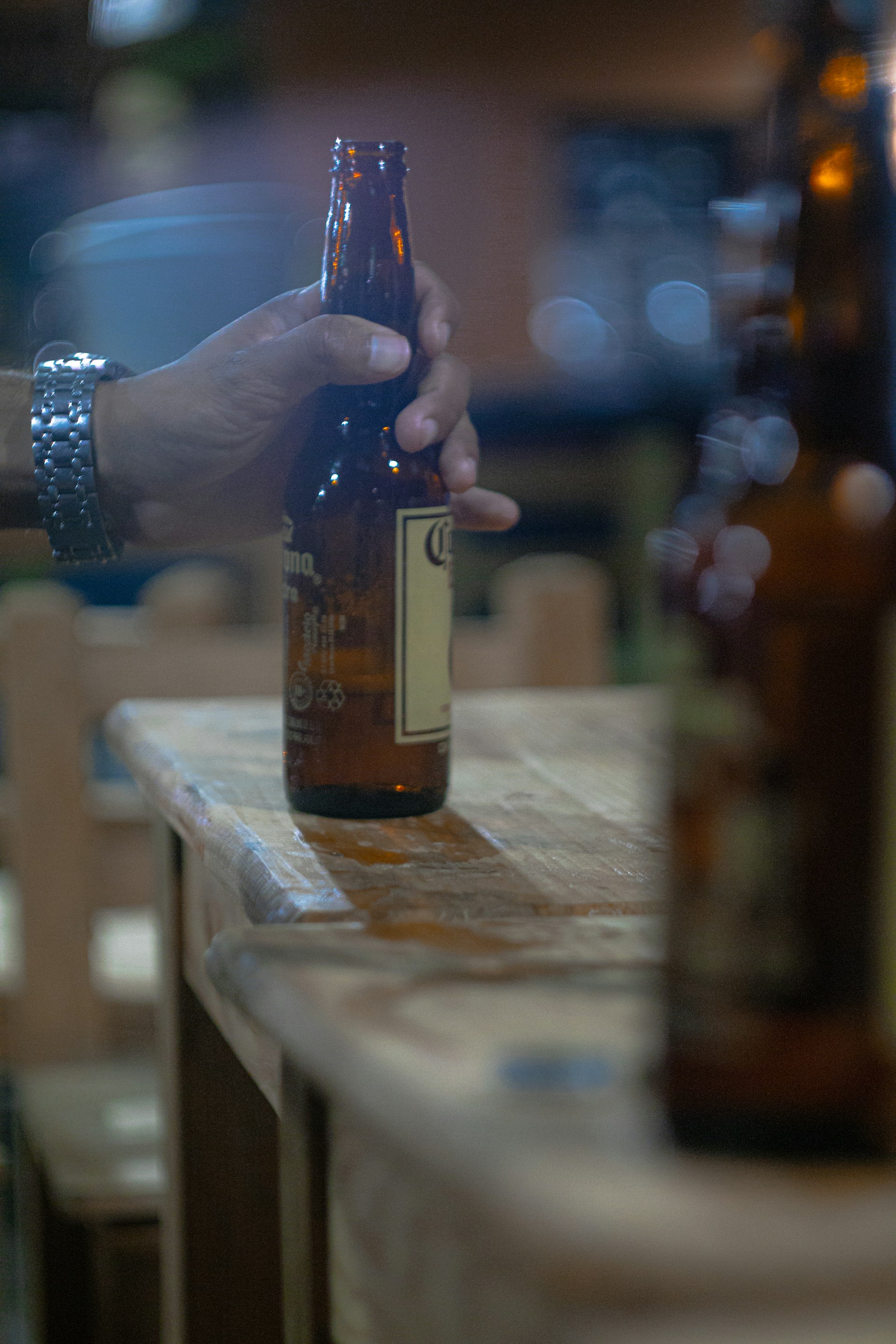 a hand holding a bottle of alcohol