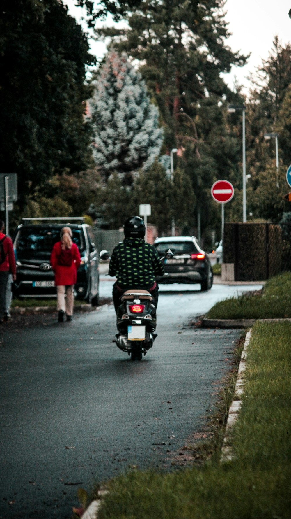 a person riding a scooter down a street