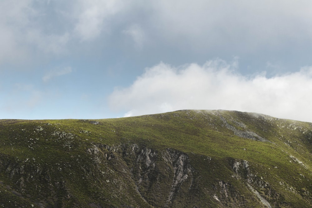 a mountain with a cloudy sky