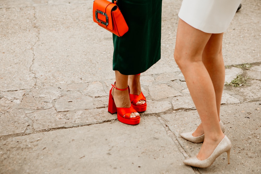 a pair of people wearing orange shoes