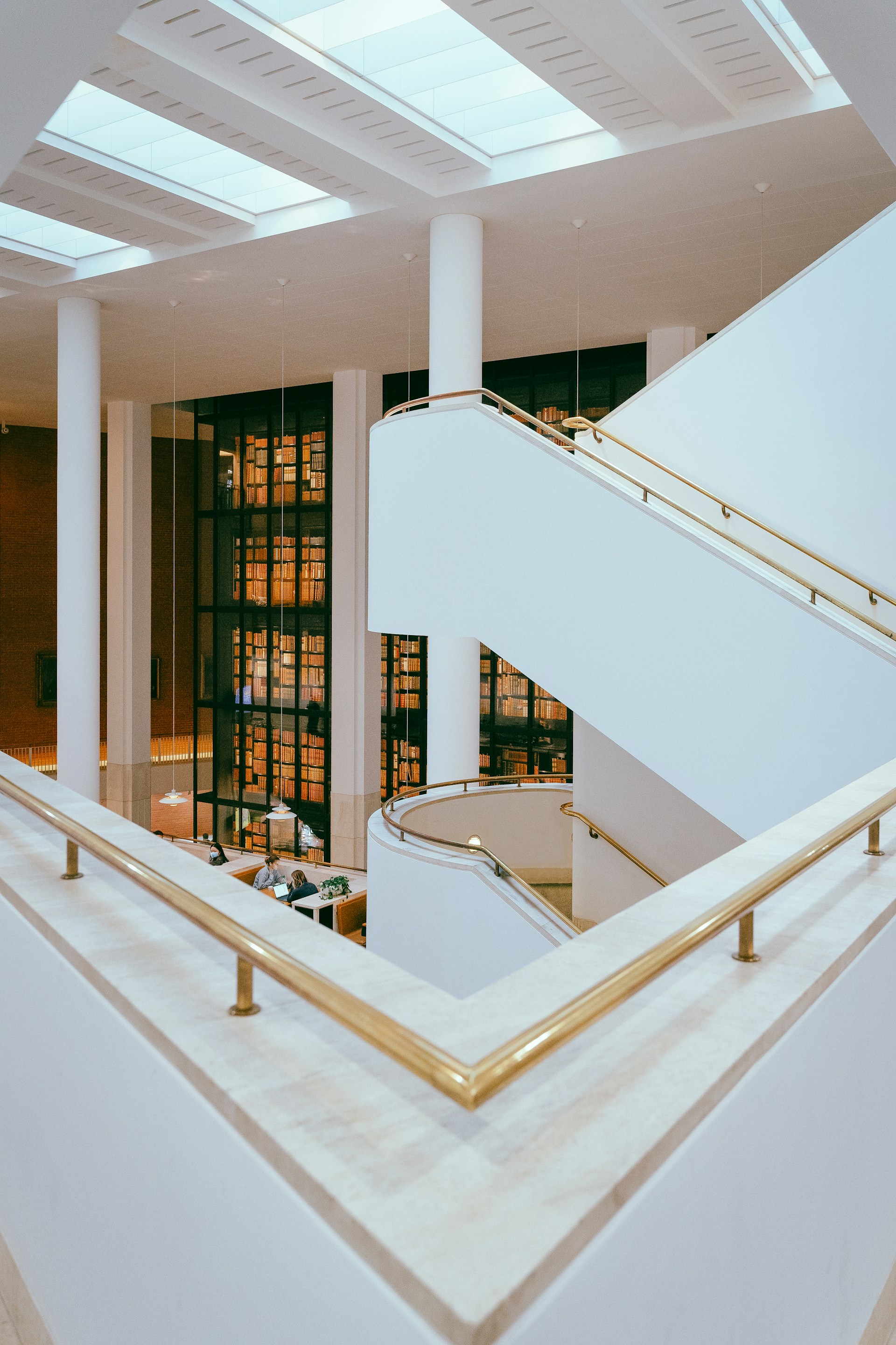 a white staircase with a glass door