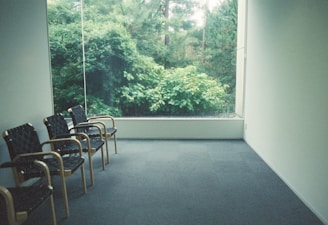a room with chairs and a window