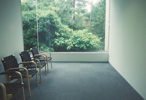 a room with chairs and a window