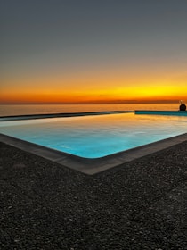 Evening glow over the salt water pool reflecting the calming sky at Heart Boutique Villa.