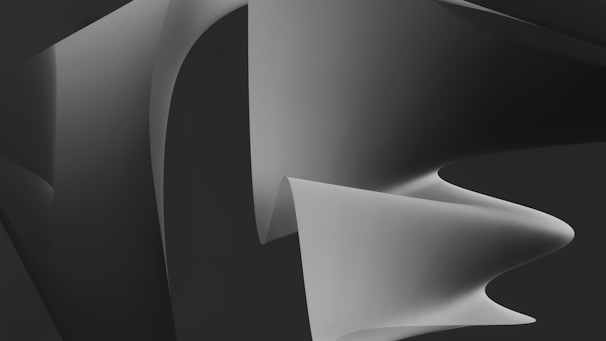 An artistic icon featuring flowing organic shapes in deep gray and black tones.