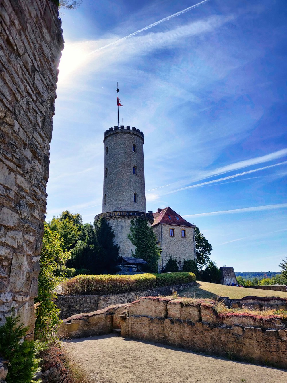 a stone tower with a flag on top