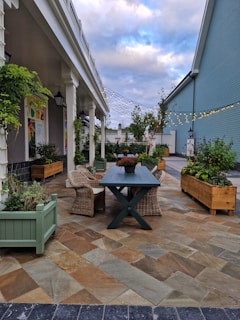 a courtyard with a table and chairs