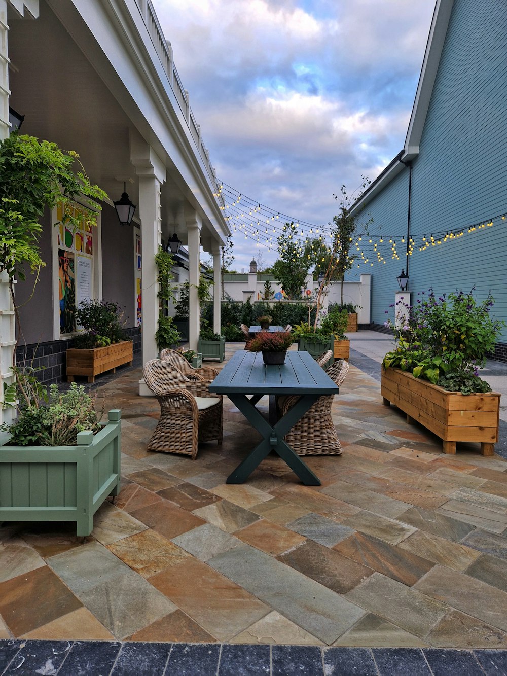 a courtyard with a table and chairs