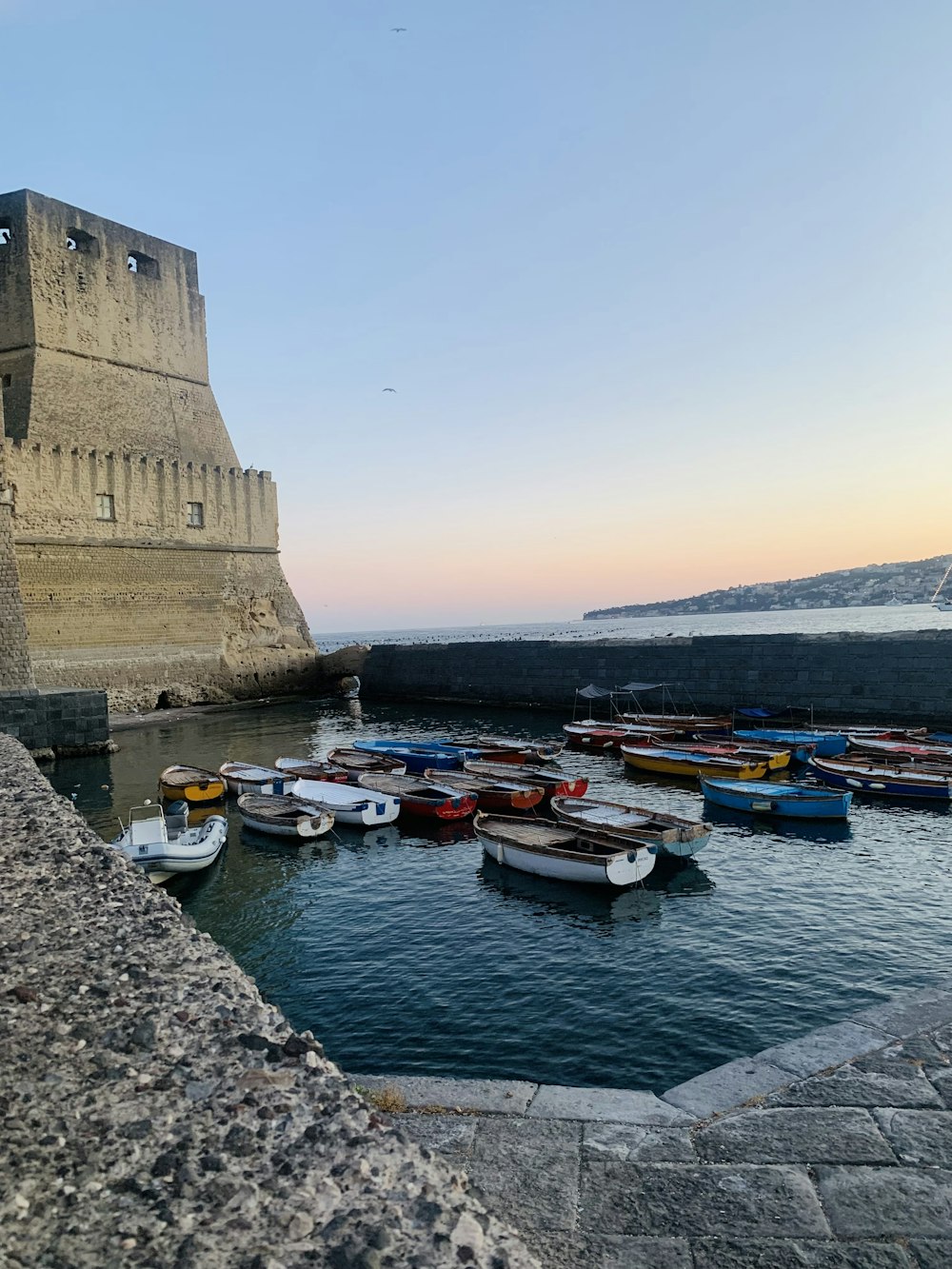 a group of boats sit in a harbor