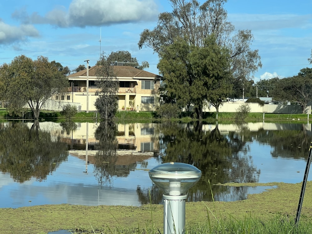 a pond with a house in the background