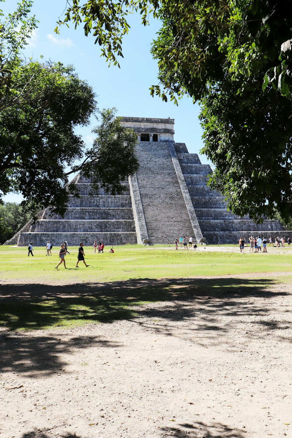 people walking around a pyramid