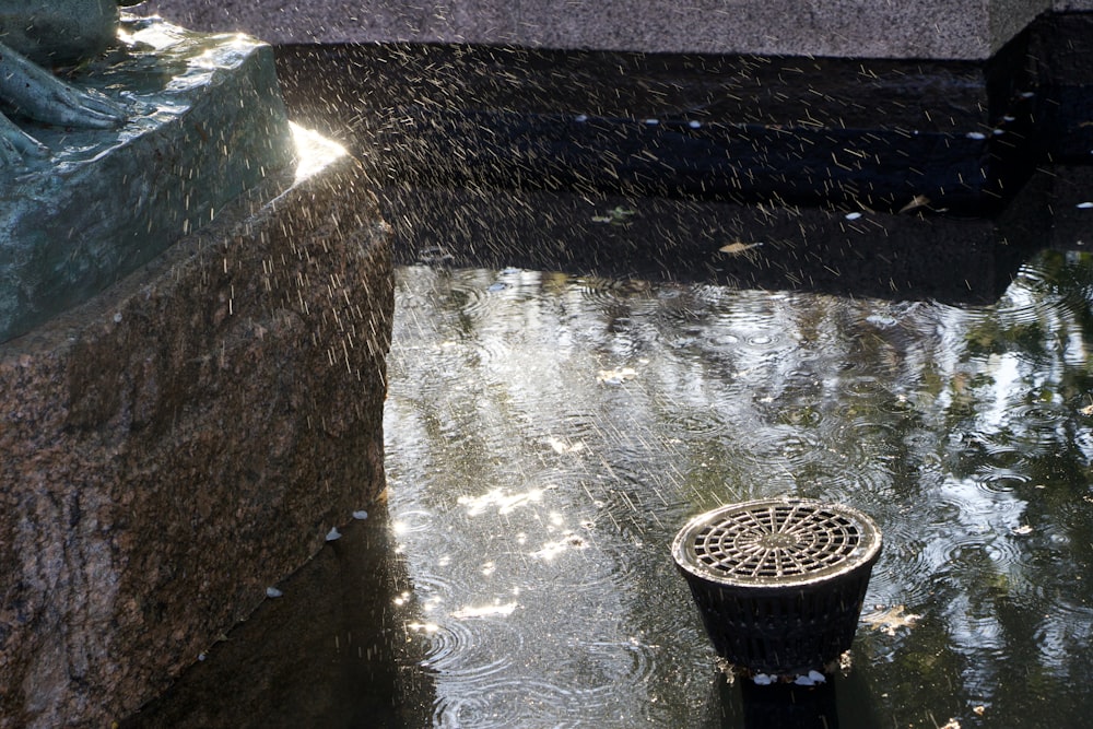 a bucket in a water fountain