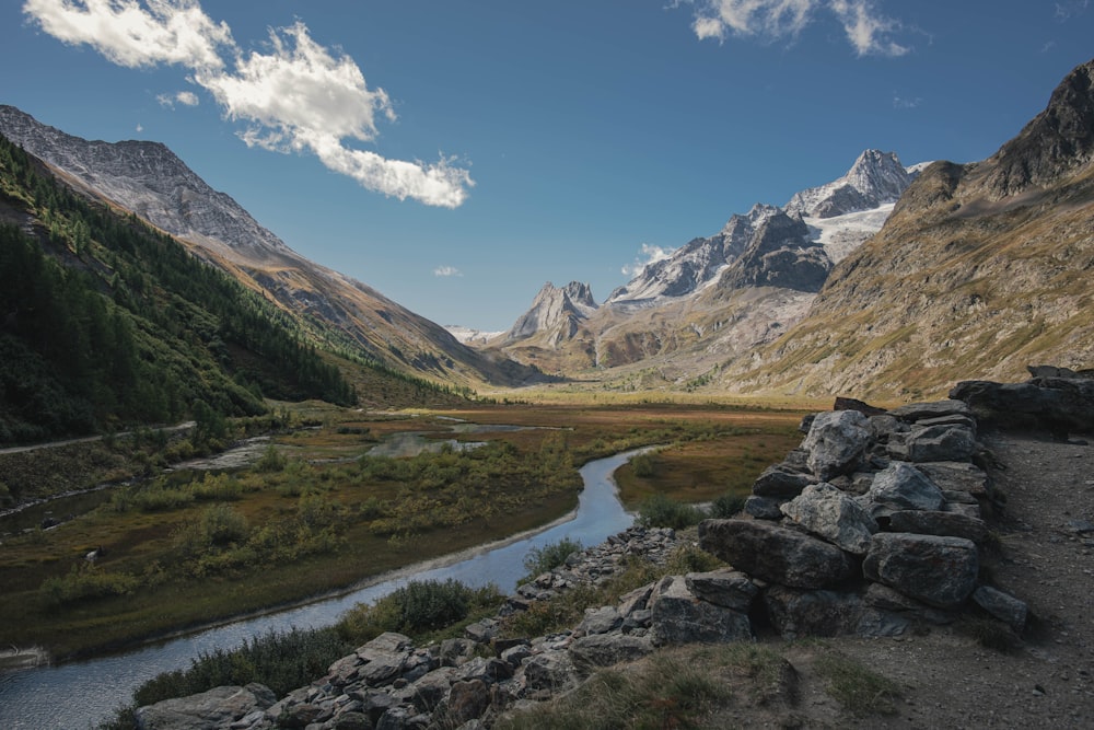 a river running through a valley between mountains