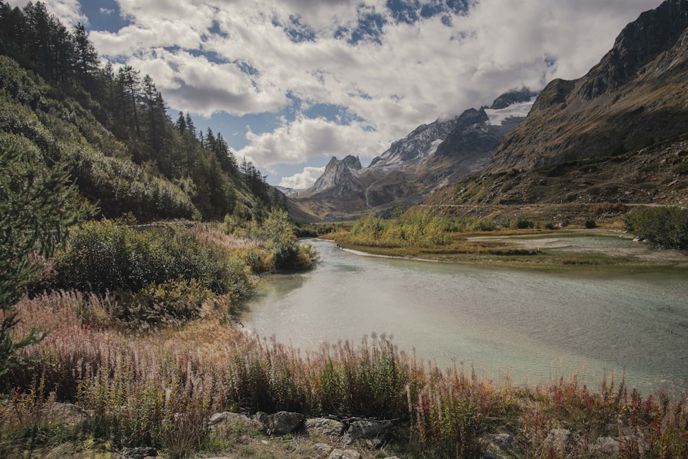 a river running through a valley between mountains