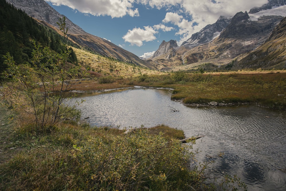 a river running through a valley between mountains