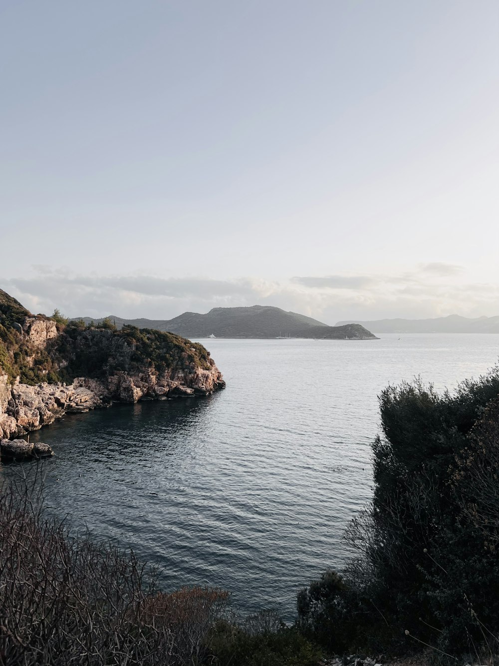 a body of water with hills around it