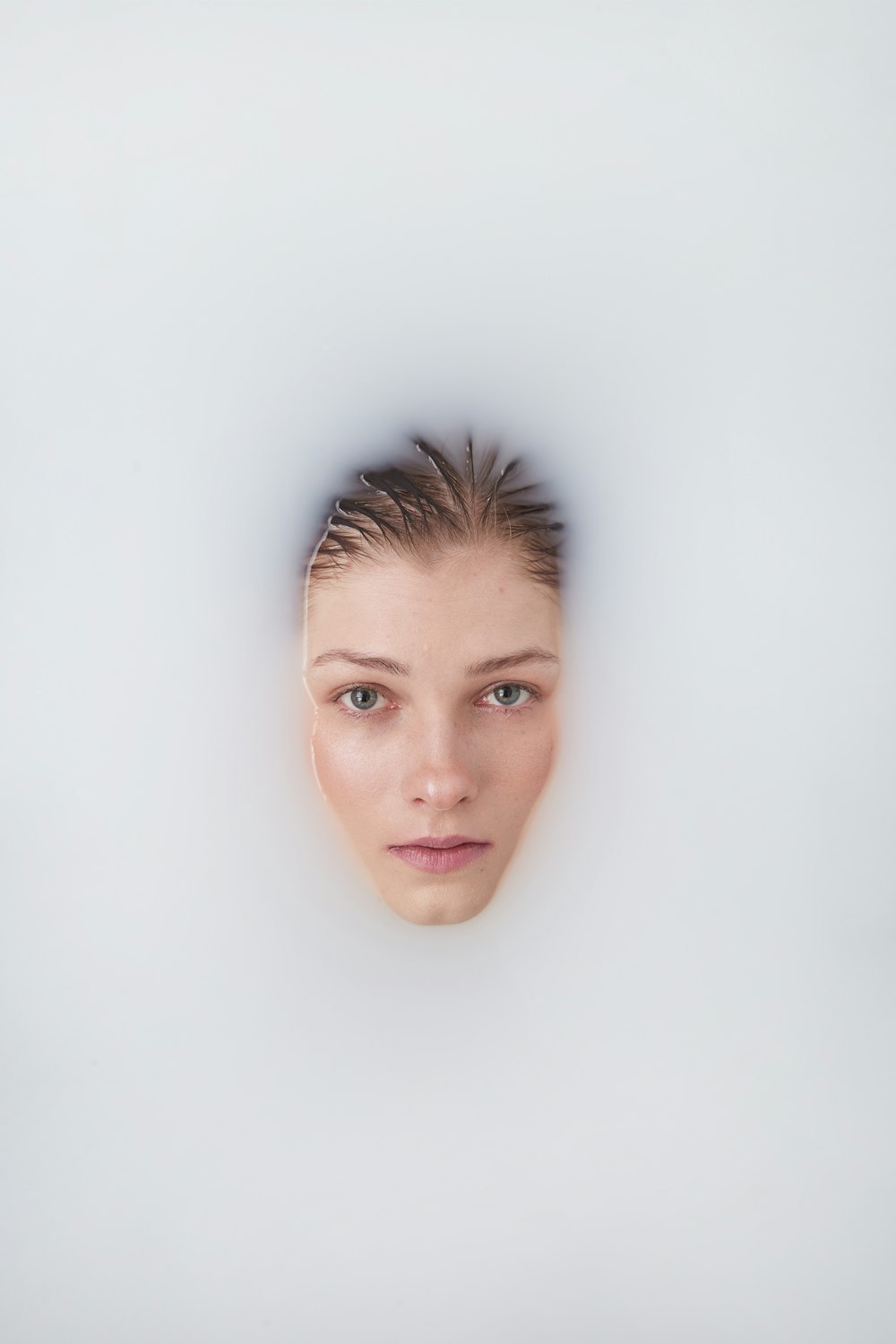 a woman's face with a white background