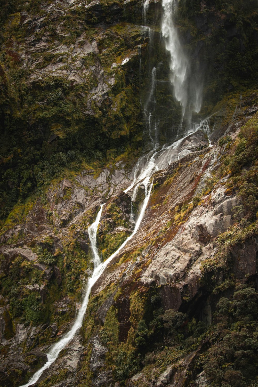 a waterfall over a rocky cliff
