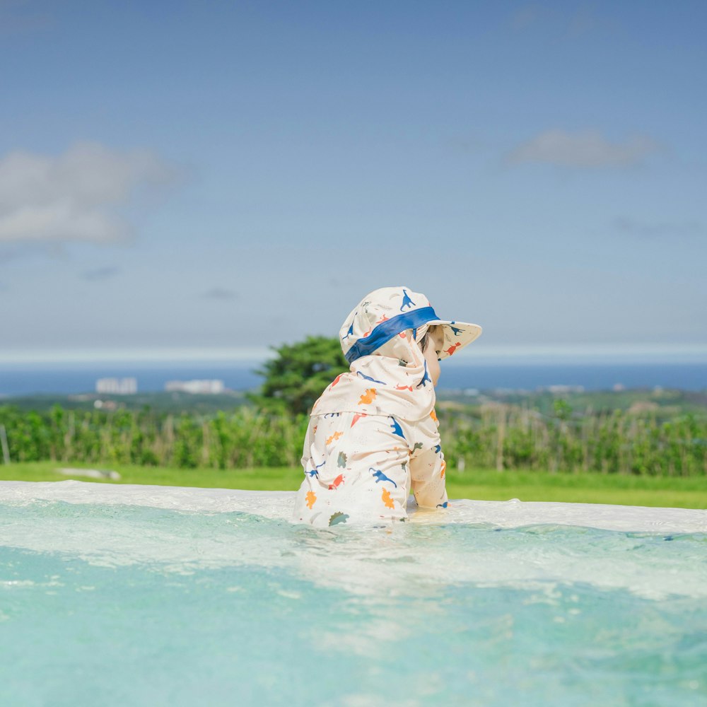 a baby in a hat in the water