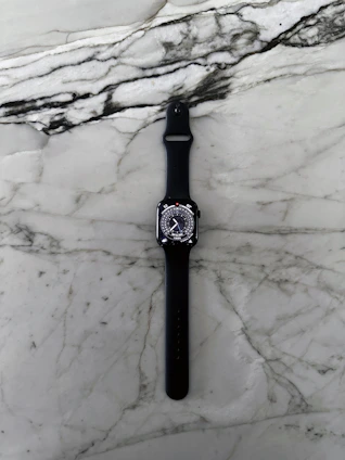 Sleek modern smartwatch with a gold frame displayed on a marble surface