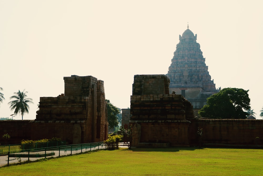 a large stone building with a fence in front of it